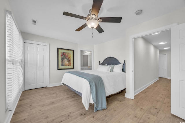 bedroom with ceiling fan, a closet, and light hardwood / wood-style floors