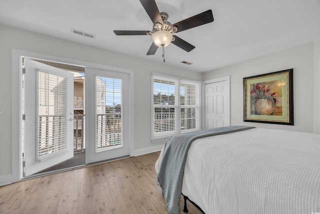 bedroom with ceiling fan, a closet, and light hardwood / wood-style flooring