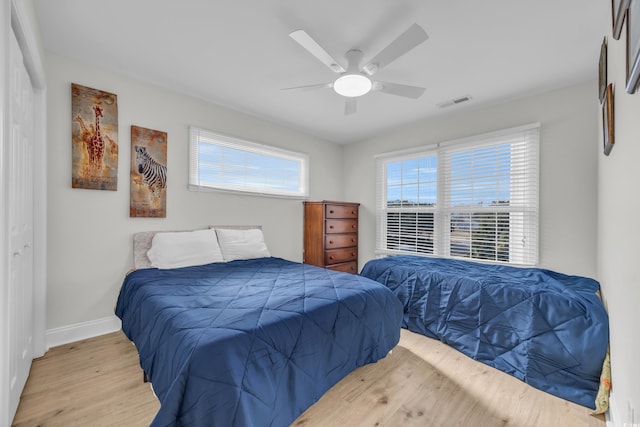 bedroom with ceiling fan and light hardwood / wood-style floors