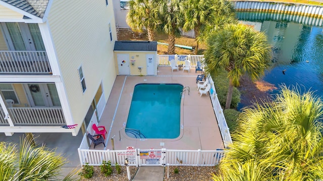 view of pool with a patio area and a water view