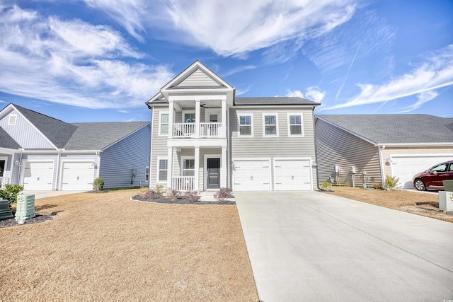 view of front of property featuring covered porch, a balcony, a garage, and ceiling fan