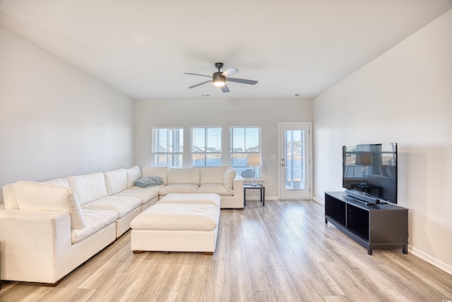 living room with ceiling fan and light hardwood / wood-style floors