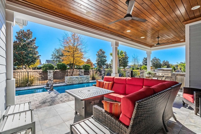 6105 Bolsena Pl, Myrtle Beach, SC 29577 - fenced backyard with exterior kitchen, an outdoor hangout area, a ceiling fan, and a patio area