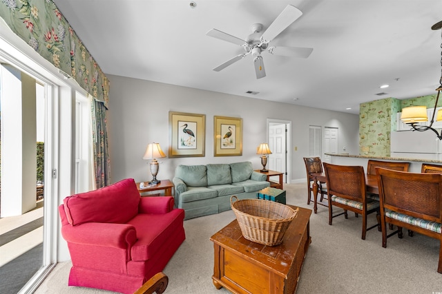 living room with ceiling fan and light colored carpet