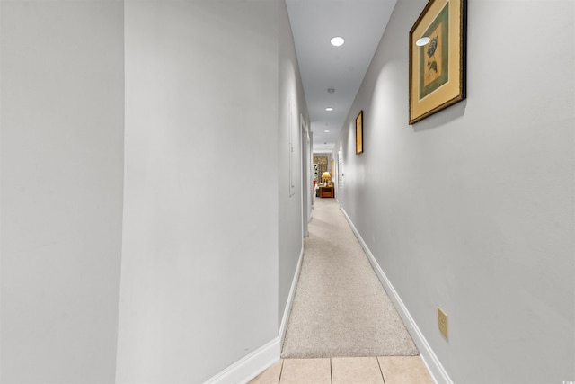 hall featuring light colored carpet