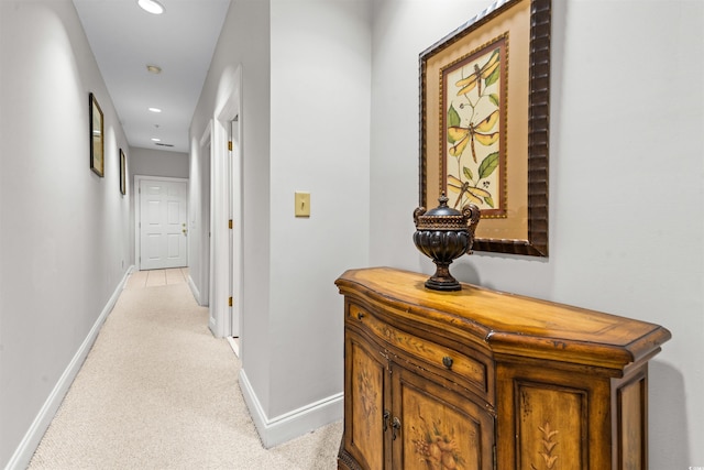 hall with light colored carpet