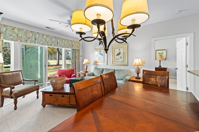 interior space featuring ceiling fan with notable chandelier