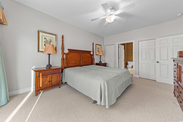 carpeted bedroom featuring ensuite bathroom and ceiling fan