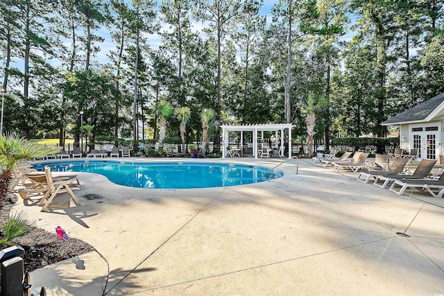 view of pool with a pergola and a patio area