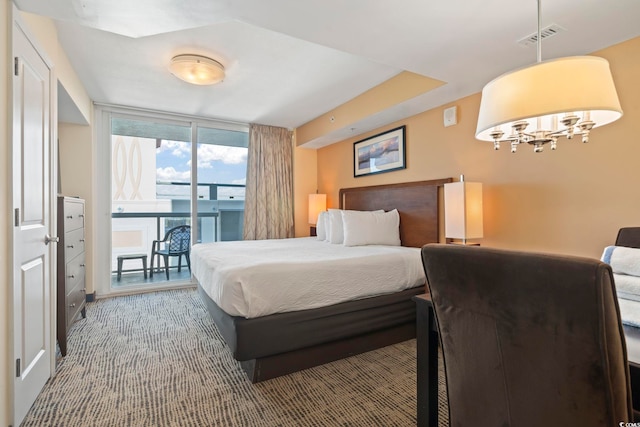 bedroom with access to outside, carpet floors, and expansive windows