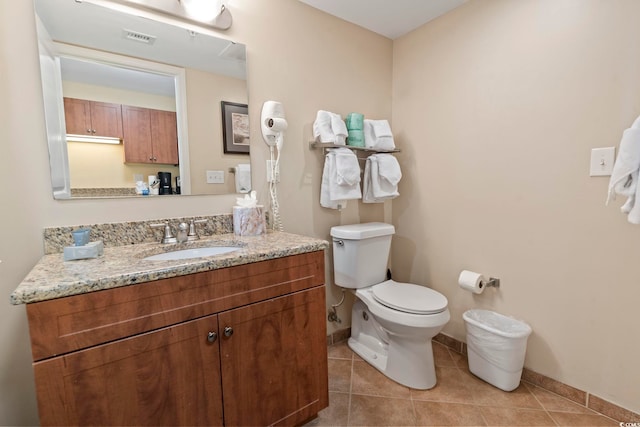 bathroom with tile patterned floors, vanity, and toilet