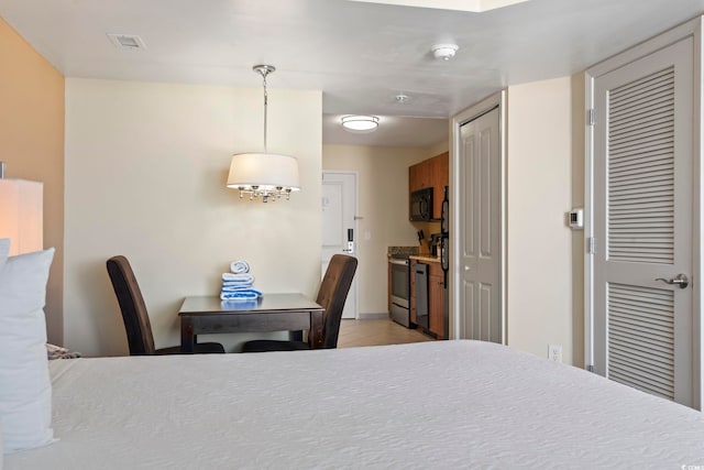 bedroom with light tile patterned flooring and a closet