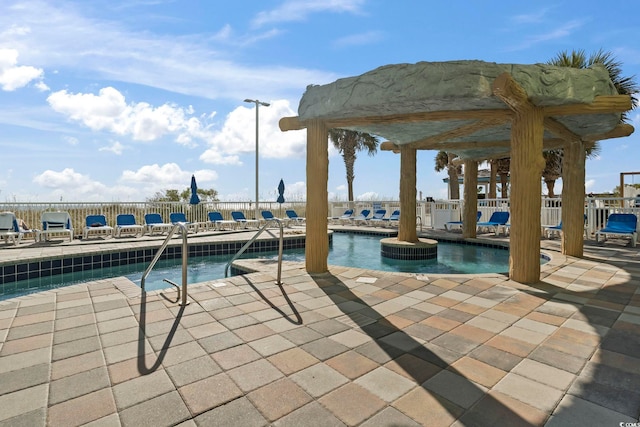 view of swimming pool featuring a patio area and a water view