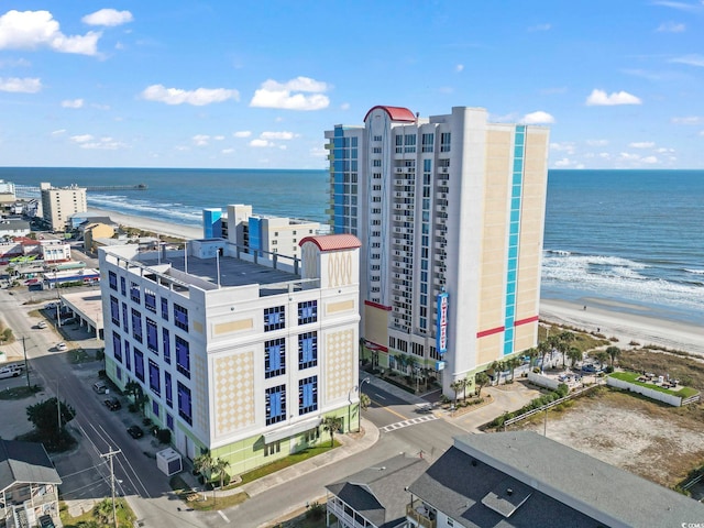 drone / aerial view with a water view and a beach view