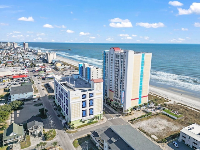 drone / aerial view featuring a beach view and a water view