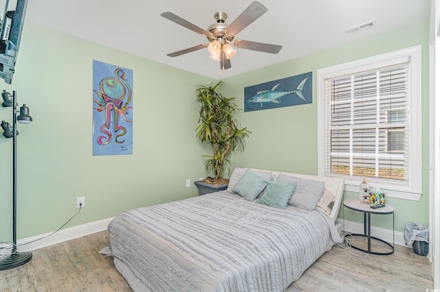 bedroom with light wood-type flooring and ceiling fan