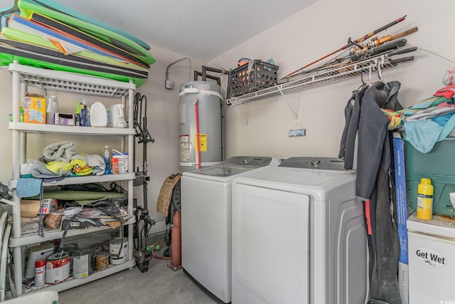 clothes washing area with separate washer and dryer and water heater