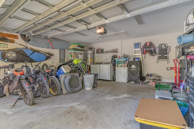 garage featuring separate washer and dryer, a garage door opener, and water heater