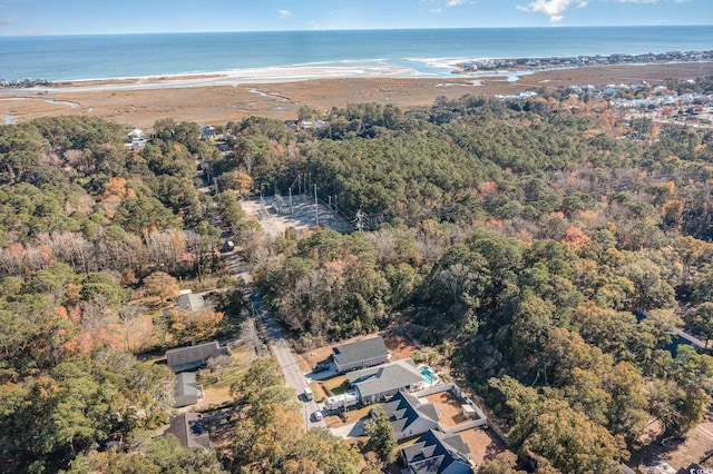 birds eye view of property featuring a water view and a beach view