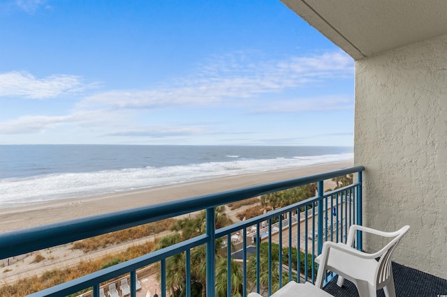 balcony featuring a view of the beach and a water view