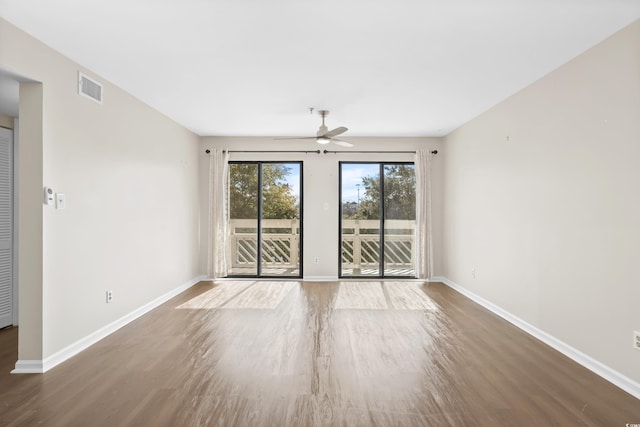 spare room with hardwood / wood-style flooring and ceiling fan