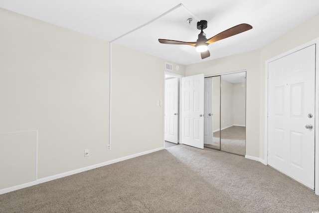 unfurnished bedroom with carpet, ceiling fan, and a closet