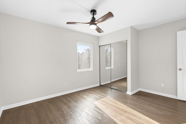 unfurnished bedroom featuring wood-type flooring, a closet, and ceiling fan