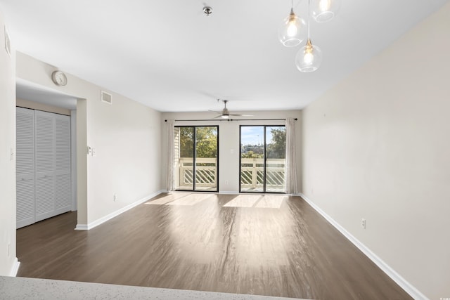 spare room featuring dark hardwood / wood-style floors and ceiling fan