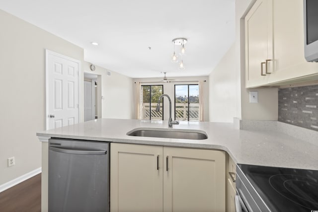 kitchen with dark hardwood / wood-style flooring, stainless steel appliances, ceiling fan, sink, and cream cabinets