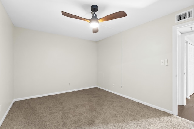 carpeted spare room with ceiling fan