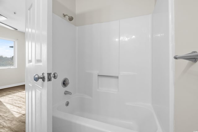 bathroom featuring shower / tub combination and wood-type flooring