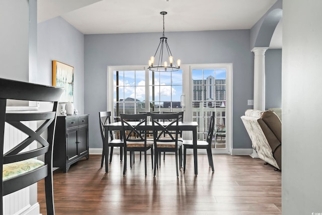 dining space with a wealth of natural light, dark wood-type flooring, and a notable chandelier