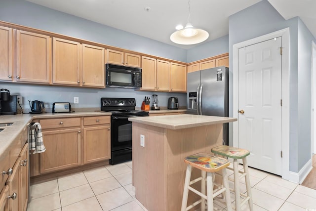 kitchen with a kitchen breakfast bar, black appliances, light tile patterned floors, a center island, and hanging light fixtures