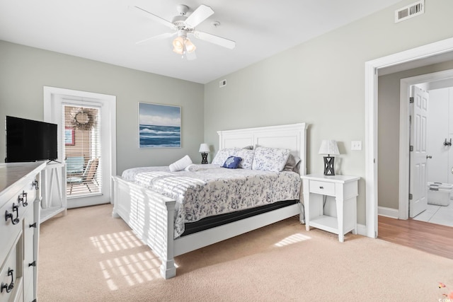 bedroom with ceiling fan, ensuite bathroom, light carpet, and access to outside