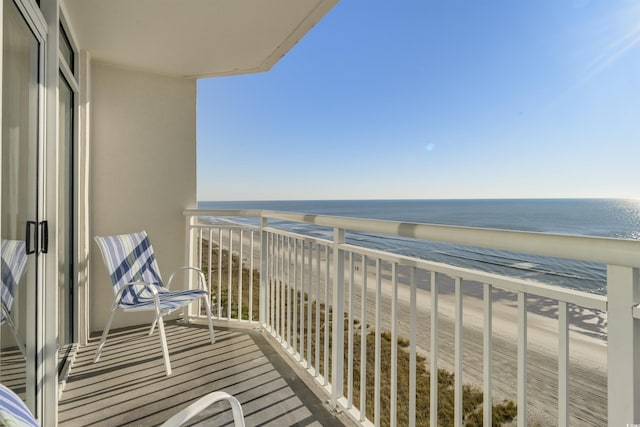 balcony with a water view and a beach view