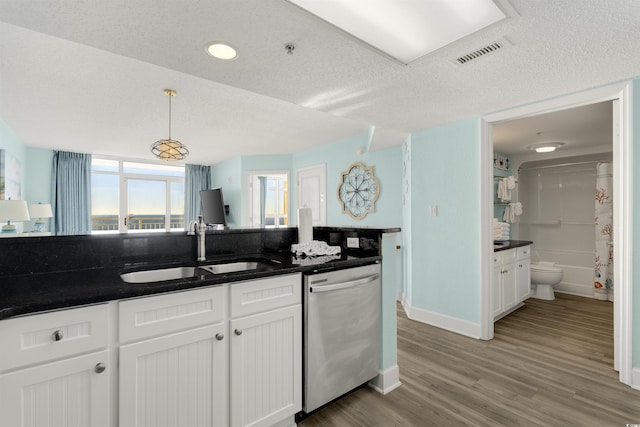 kitchen with sink, decorative light fixtures, dishwasher, light hardwood / wood-style floors, and white cabinetry