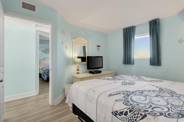 bedroom with light wood-type flooring