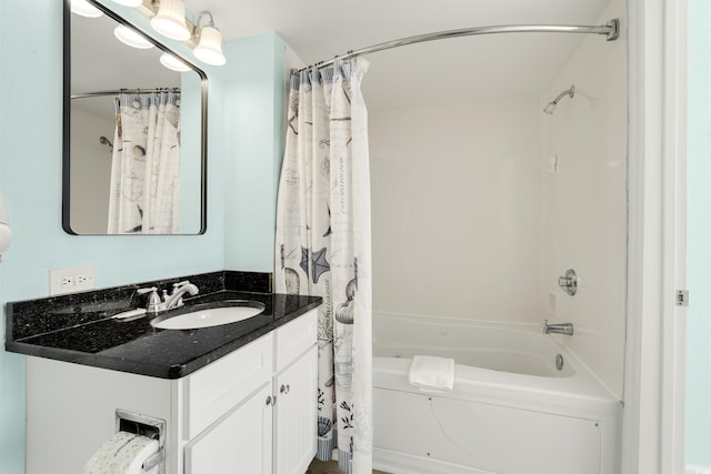 bathroom featuring shower / bath combo and vanity