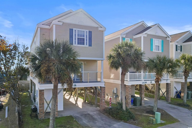 coastal inspired home featuring a porch and a carport