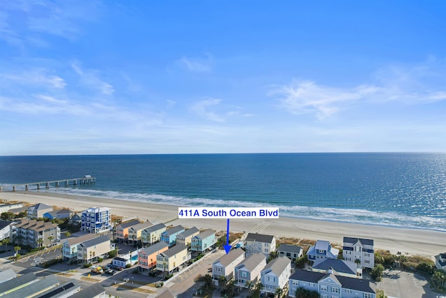 drone / aerial view featuring a water view and a beach view