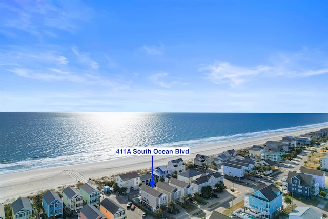 drone / aerial view with a water view and a view of the beach