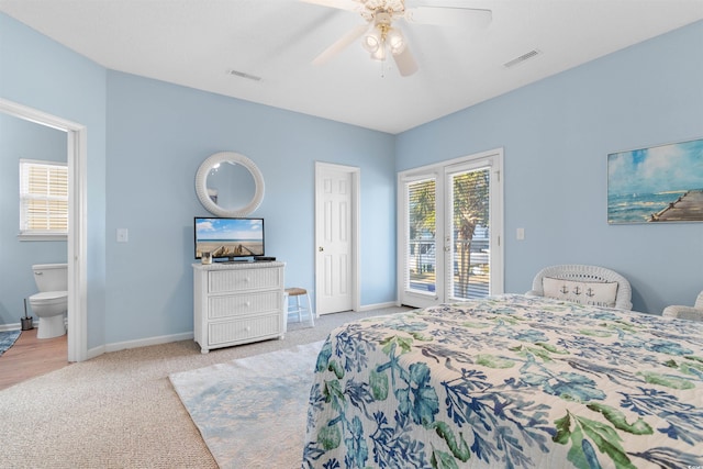 bedroom with ceiling fan, access to exterior, ensuite bathroom, and light carpet