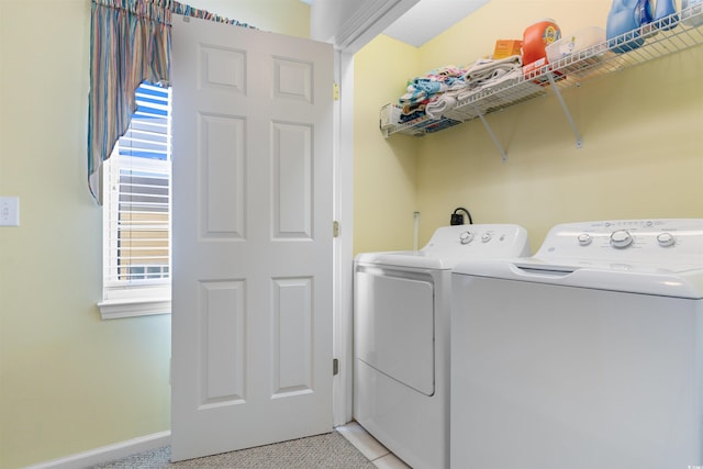 laundry room featuring light tile patterned floors and washing machine and dryer