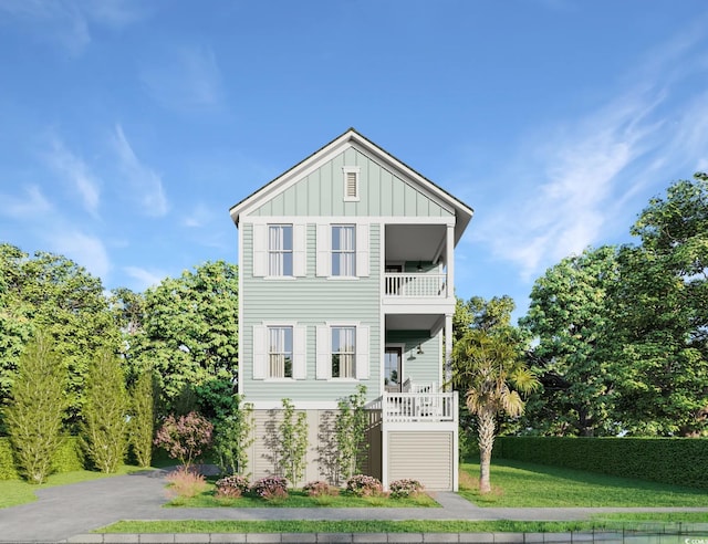 view of front of house featuring a balcony and a front yard