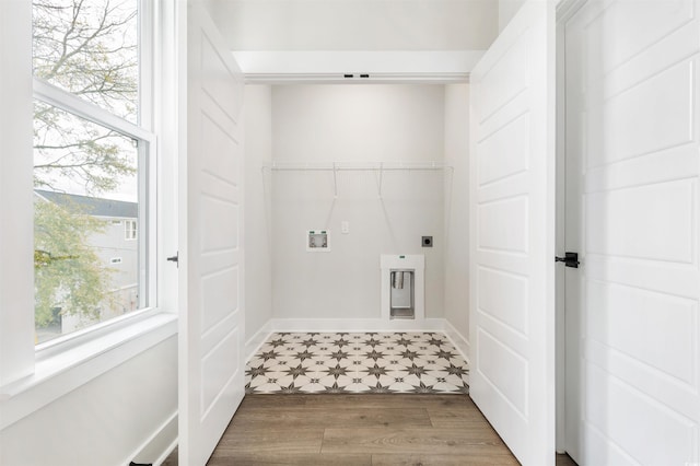 clothes washing area with electric dryer hookup, hookup for a washing machine, and wood-type flooring