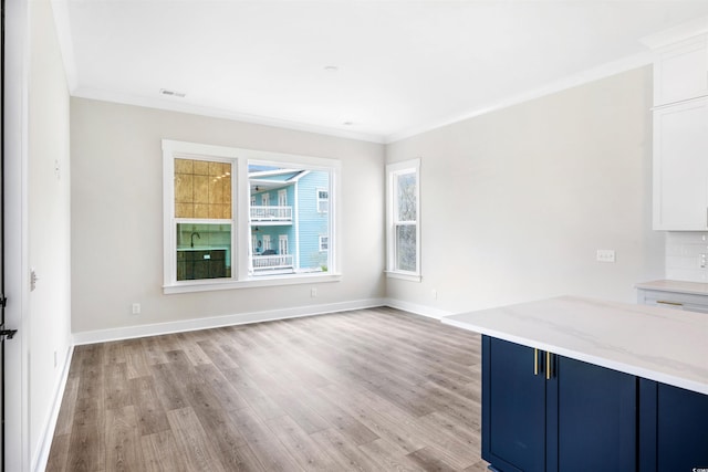 interior space featuring ornamental molding and light hardwood / wood-style flooring