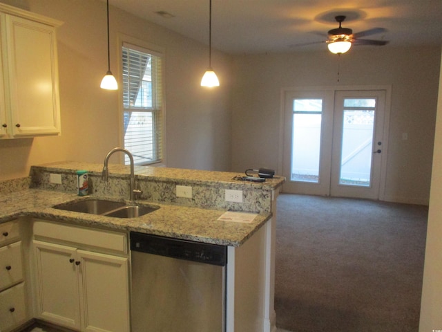 kitchen featuring hanging light fixtures, sink, stainless steel dishwasher, and kitchen peninsula