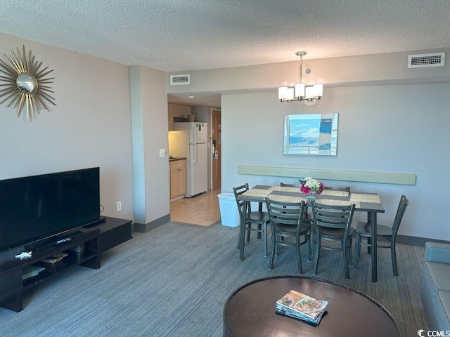 2301 S Ocean Blvd Unit 1002, North Myrtle Beach, SC 29582 - dining area with a textured ceiling and a chandelier
