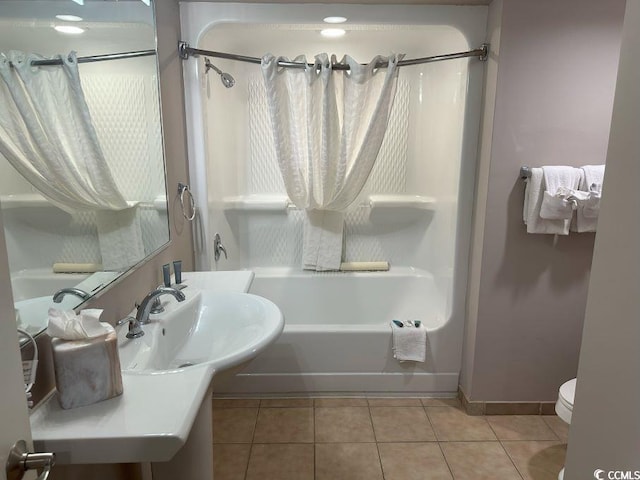 full bathroom featuring toilet, tile patterned floors, shower / bathtub combination with curtain, and sink