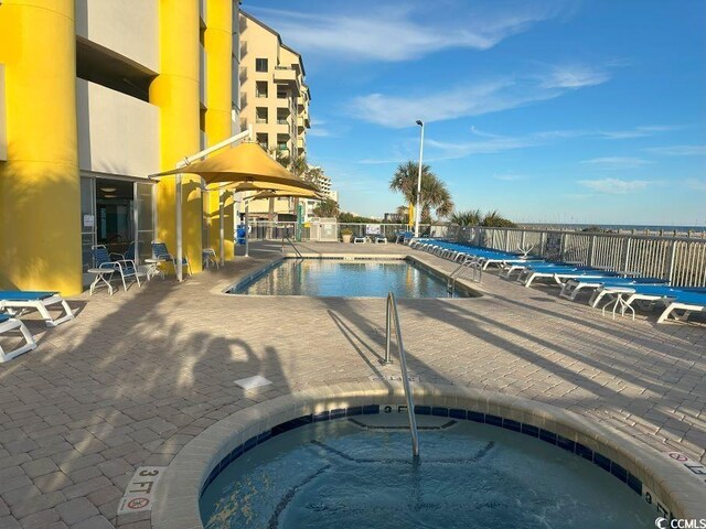 2301 S Ocean Blvd Unit 1002, North Myrtle Beach, SC 29582 - community pool with a community hot tub and a patio area